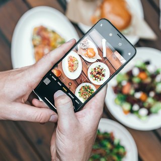 Hand snapping a photo on a phone