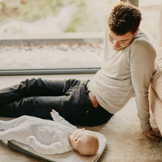 Dad face to face with his baby during a diaper change