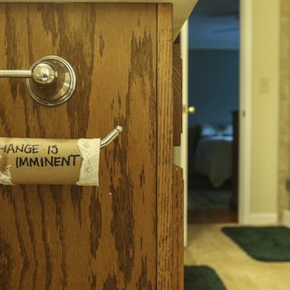 Restroom door with a brass Occupied sign